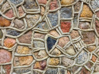 stone wall as background or texture. modern style design decorative uneven cracks real stone wall surface with cement