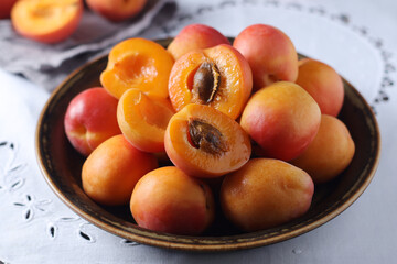 Fresh ripe apricots in bowl in rustic style