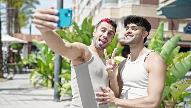 Two men couple smiling confident make selfie by smartphone at park
