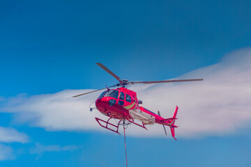 Fototapeta na wymiar Helicopter and crew fighting a wildfire