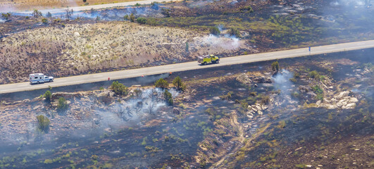 Wildland engine and crew engage in suppression activities on a vegetation fire