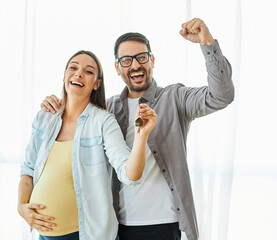 couple key house happy young home celebrating celebration achievement new investment pregnant mother pregnancy real estate apartment holding buying love belly