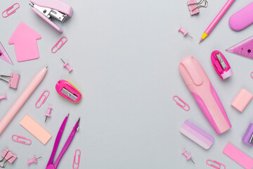 Pink school stationery on color backgroung, top view