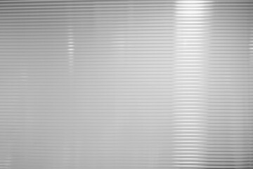Fototapeta premium White Horizontal Plastic Striped Partition Background with Reflection of Light Beam.