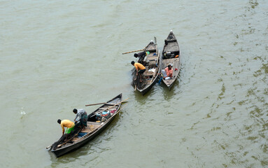 Obraz premium Fishermen are fishing in the river below Megna Bridge near in dhaka Bangladesh