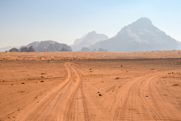 Fototapeta na wymiar Arabian desert. Wadi Rum. Space landscape. Footprints in the sand. Filming location for many science fiction films.