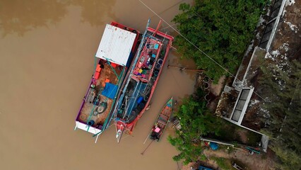 Aerial view of the Philippines traditional fishing boats. Top view Philippines fisherman village with fishing boats on jetty. The Philippines fishing boats help the locals catch fish polluted water