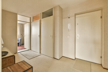 a room with two doors and an open door on the other side of the room there is a mirror in the wall