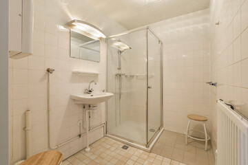 a bathroom with a sink, mirror and toilet paper on the wall next to the shower stall in the room