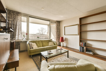 a living room with two couches and a coffee table in front of a large window looking out onto the street