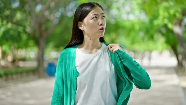 Young chinese woman sweating at park