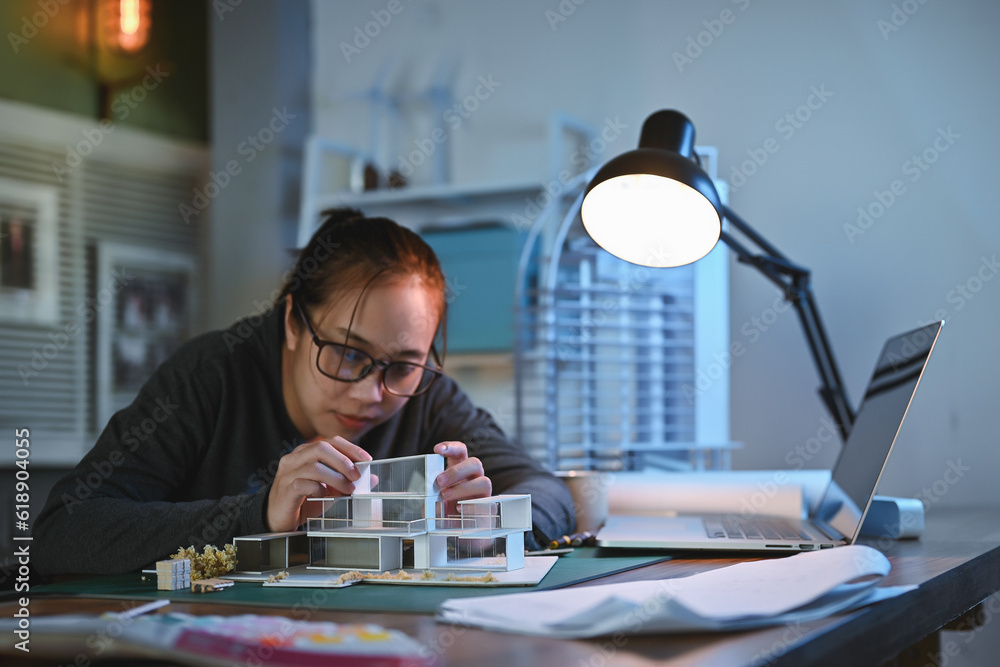 Poster architecture students diligently make house model building samples with paper architecture and tools