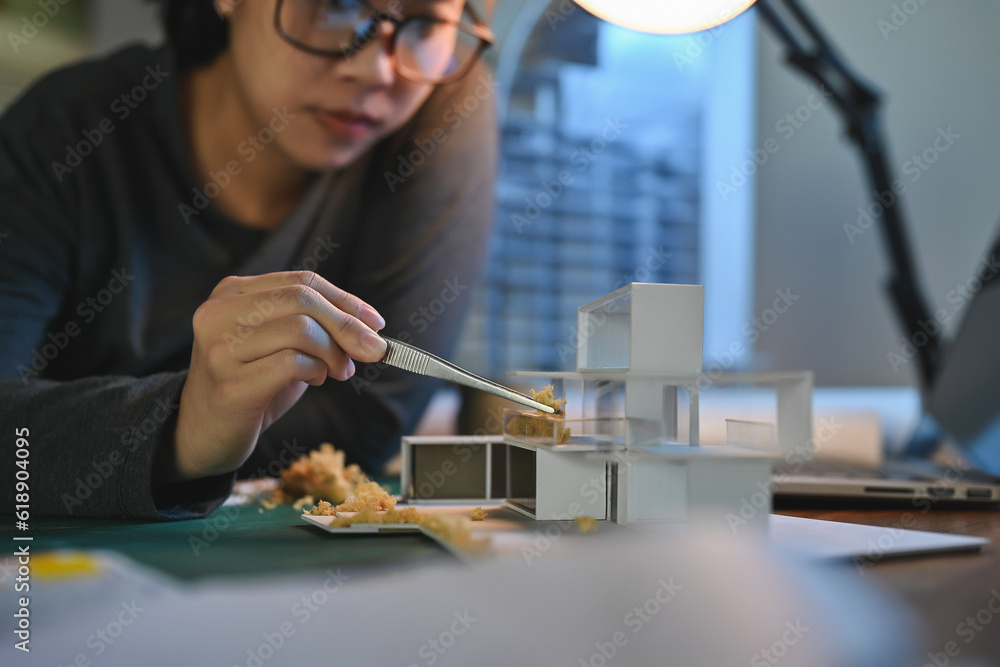 Poster architecture students diligently make house model building samples with paper art architecture tools