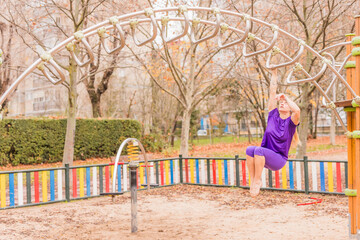 Calisthenics park fitness healthy wellbeing lifestyle in outdoor work out. mid hispanic woman.