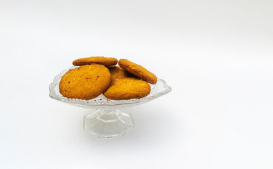 oatmeal cookies on a crystal platter on a white background.