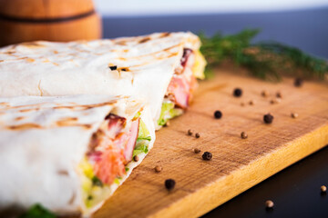 Delicious kebab with meat, lettuce, tomato, onion and sauce with french fries.