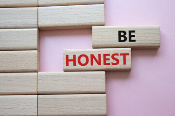 Be honest symbol. Wooden blocks with words Be honest. Beautiful pink background. Business and Be...
