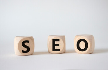 SEO - Search Engine Optimization symbol. Wooden blocks with words SEO. Beautiful white background. Business and SEO concept. Copy space.