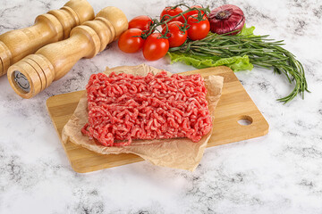 Raw minced beef meat on cutting board