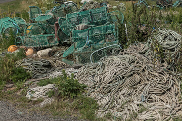 abandoned lobster pots and rope on the grass