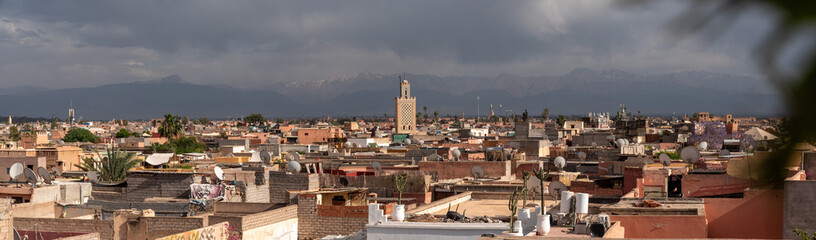 Scenic view of the Marrakech medina and the Atlas mountains in the background during stormy weather