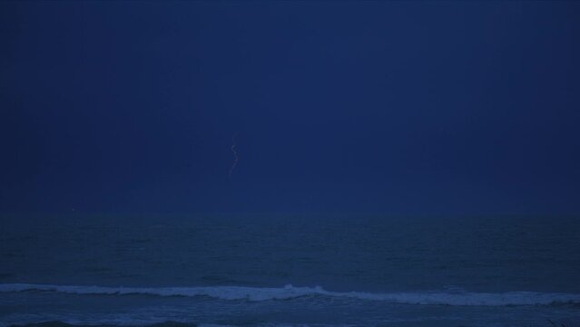 Breaking waves Atlantic ocean storm fork lightning night time
