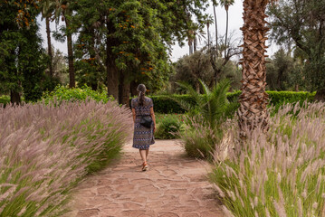 A young woman walking through the park el Harti in Marrakech