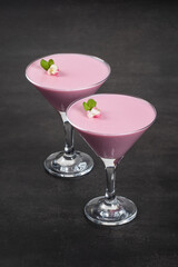 Pink tea matcha cream dessert, Pitaya Panna Cotta in martini glass. Dark gray background	