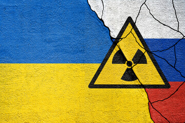 Flag of Ukraine and Russia painted on wall. Russian and ukrainian war.Zaporizhzhia Nuclear Power...