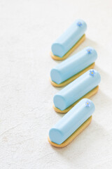 Blue tea matcha cream dessert cake bar, decorated with a small flower. On cookies. 