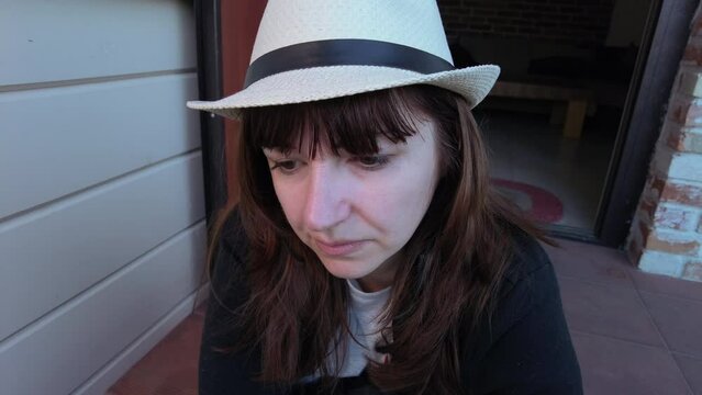 Solitude and Reflection: A Woman Contemplating on the Doorstep