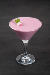 Vegan dessert. Pink tea matcha Panna Cotta in martini glass. Panna Cotta dessert with the addition...
