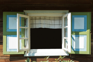 An old, colorful open window in a country cottage. Vintage style.