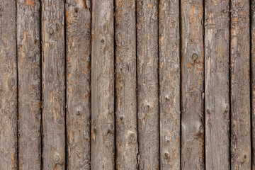  Rough wood texture. The walls of a country house are made of rough logs or boards. Log back.