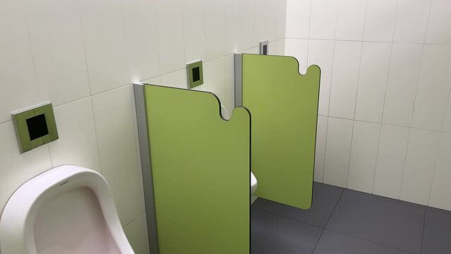 Rows of modern urinals with a sensor WC flush in a public men's room