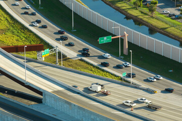 Above view of wide highway crossroads in Miami, Florida with slow driving cars during rush hour....