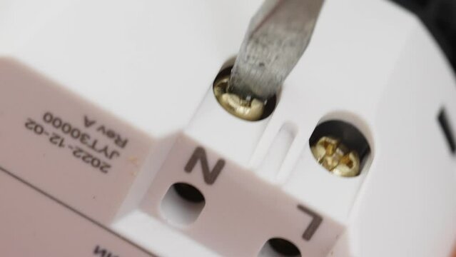 Unscrewing the output terminals of the electrical outlet