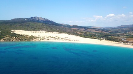 beautiful aerial view from the Atlantic towards the huge Dunes of Valdevaqueros with forest, mountains and rocks in the background, Tarifa, Andalusia, province of Cádiz, Spain