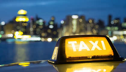 Taxi sign close-up shot on night city background