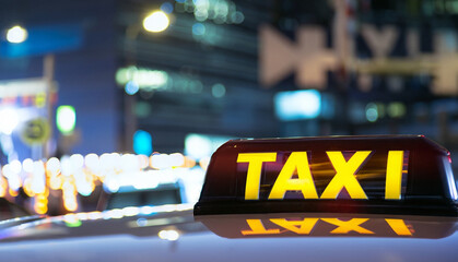 Taxi sign close-up shot on night city background