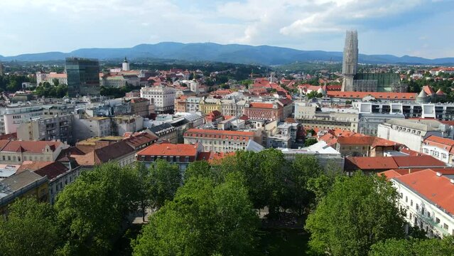 Aerial shot drone flies over Park Zrinjevac toward the city center of Zagreb, Croatia