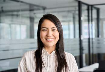 Confident smiling young professional Asian business woman corporate leader, happy japanese female employee, company sales marketing manager, standing in office, headshot portrait. - obrazy, fototapety, plakaty