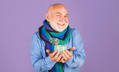 Smiling man with medicine tea. Ill man drink herbal tea wild marjoram oregano medical herb. Sick...