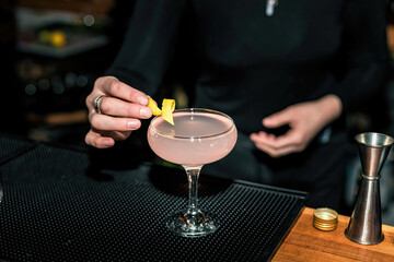 Woman finishing a drink with a piece of lemon