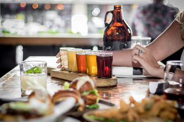 Woman reaching out for a beer taster