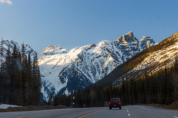Car driving on a road towards mountains