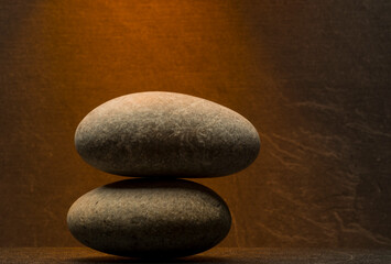 Fototapeta na wymiar two zen stone on brown background for podium product presentation background