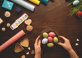 Hands of two women with Easter buns and Easter eggs. 