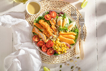 Homemade salad with chicken, salad, melon and eggs.