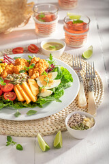 Tasty salad with chicken, eggs, tomato and melon.